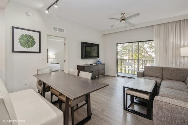 dining area featuring hardwood / wood-style floors, ceiling fan, and track lighting