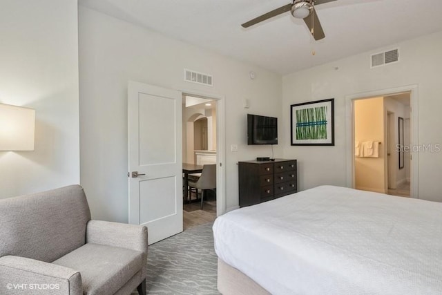 bedroom featuring hardwood / wood-style flooring, ceiling fan, and ensuite bathroom