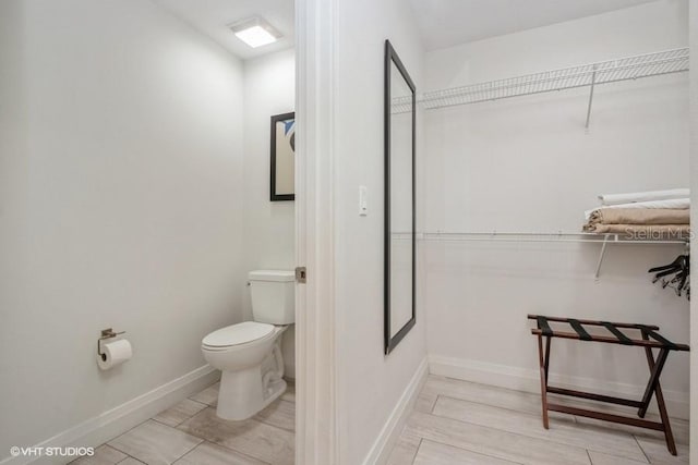 bathroom with tile flooring and toilet