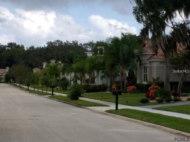 view of property's community featuring a yard