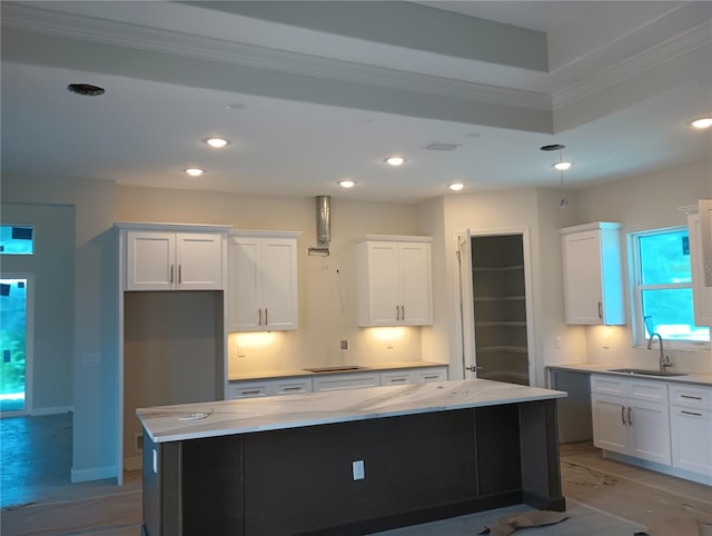 kitchen with a center island, light hardwood / wood-style floors, sink, and white cabinets