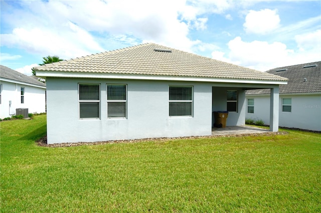 back of house with a yard, central air condition unit, and a patio area