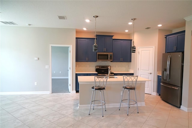 kitchen with backsplash, a kitchen breakfast bar, an island with sink, stainless steel appliances, and pendant lighting