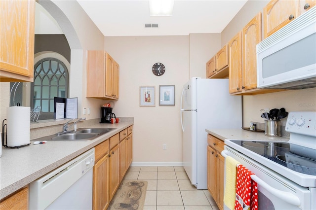 kitchen featuring white appliances, light brown cabinets, sink, and light tile floors