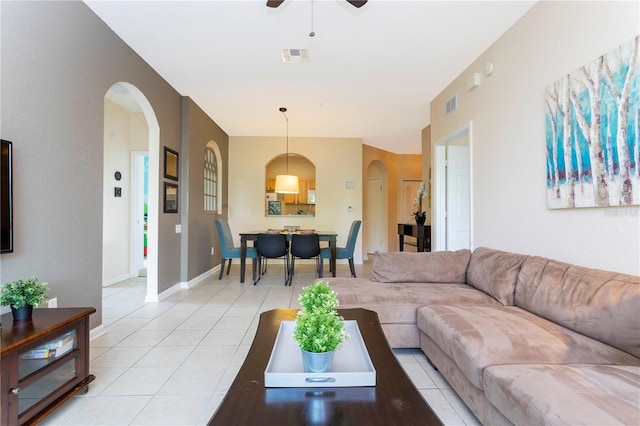 tiled living room featuring ceiling fan