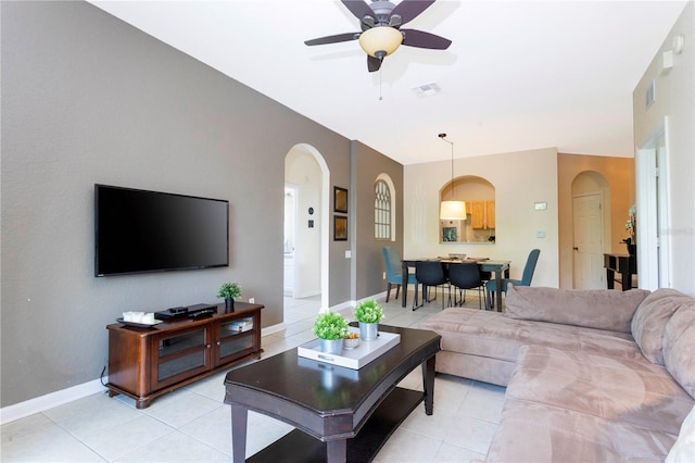 living room with light tile floors and ceiling fan