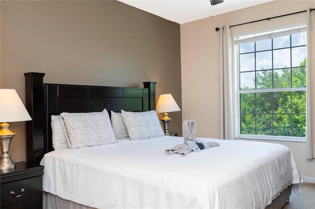 bedroom with ceiling fan and carpet