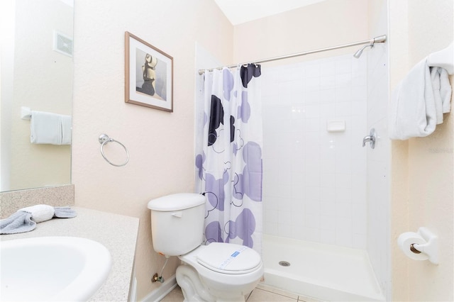 bathroom with toilet, tile flooring, a shower with shower curtain, and vanity