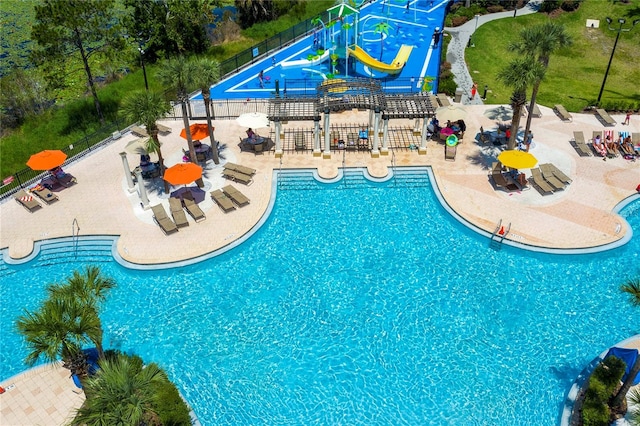 view of pool featuring a water slide and a patio area