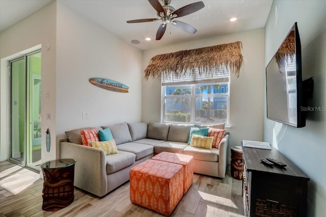 living room with ceiling fan and light wood-type flooring