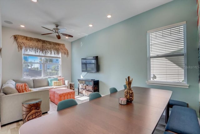 dining space with ceiling fan and light wood-type flooring