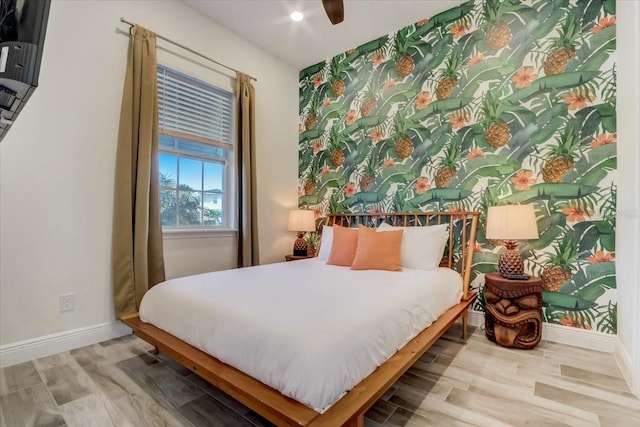 bedroom with ceiling fan and light wood-type flooring