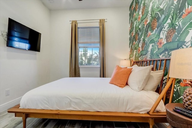 bedroom with dark wood-type flooring