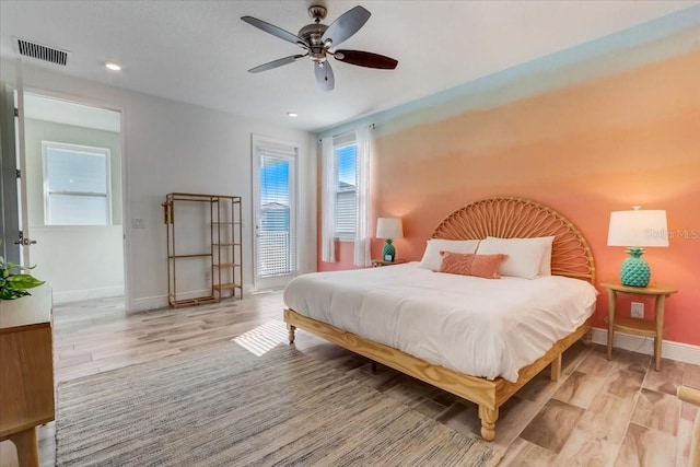 bedroom featuring ceiling fan and light hardwood / wood-style flooring