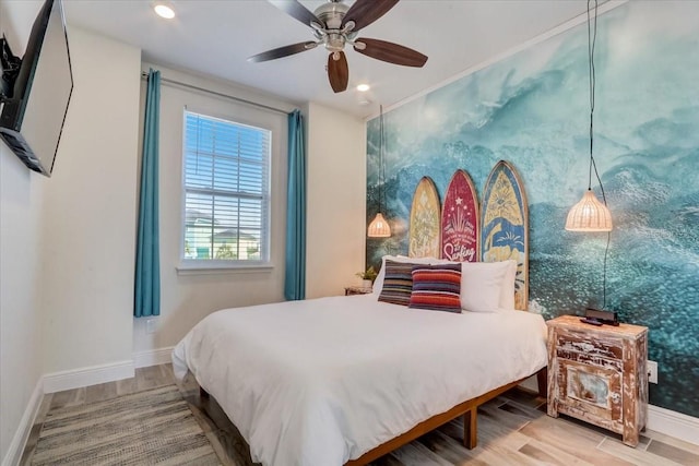 bedroom with ceiling fan and light hardwood / wood-style flooring