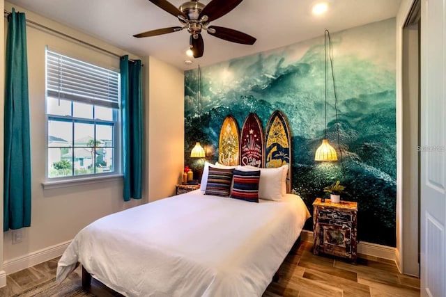 bedroom with ceiling fan and hardwood / wood-style flooring