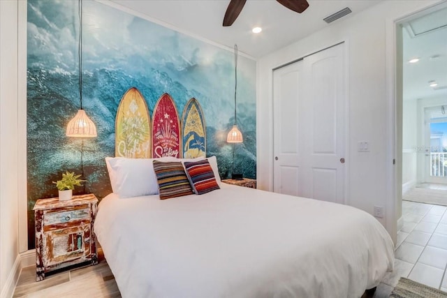 bedroom with light tile flooring, a closet, and ceiling fan