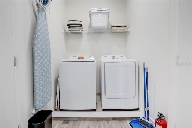 washroom featuring light hardwood / wood-style floors and washer and clothes dryer