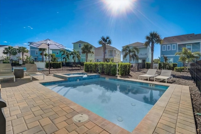 view of pool featuring a patio and an in ground hot tub