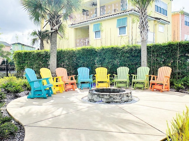 view of terrace with a balcony and a fire pit