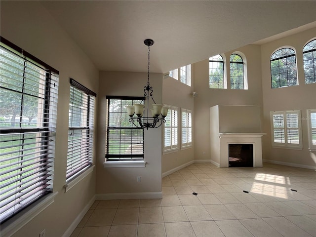 interior space with a notable chandelier and light tile floors