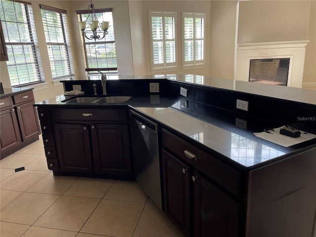 kitchen featuring sink, dark brown cabinetry, dishwashing machine, and a chandelier