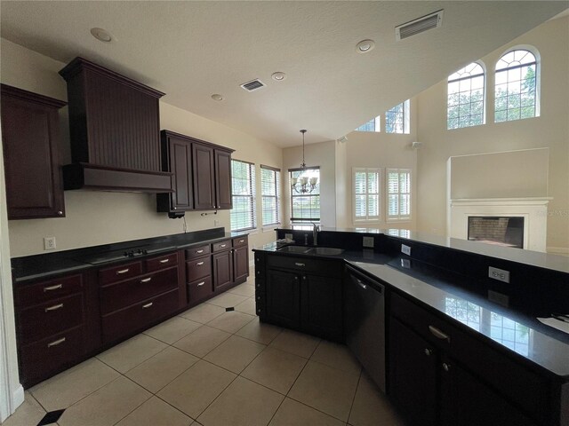 kitchen featuring sink, light tile floors, custom range hood, stainless steel dishwasher, and dark brown cabinetry