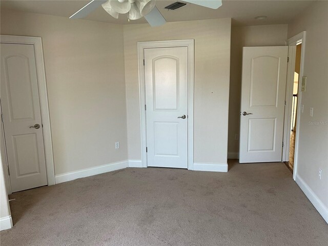 unfurnished bedroom featuring ceiling fan and dark colored carpet