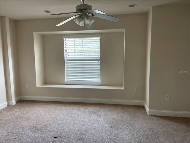 unfurnished room featuring ceiling fan and light carpet