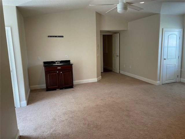 interior space with ceiling fan, lofted ceiling, and sink