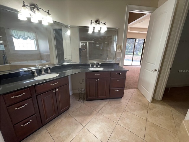 bathroom featuring vanity, tile flooring, independent shower and bath, and a healthy amount of sunlight