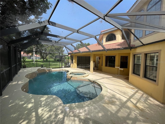 view of swimming pool featuring glass enclosure, pool water feature, a patio area, and an in ground hot tub