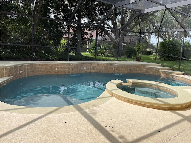 view of swimming pool with an in ground hot tub and a lanai