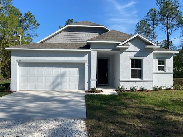 view of front of house with a garage and a front lawn