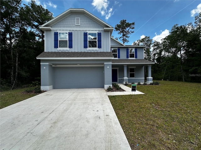 view of front of property featuring a porch, a garage, and a front yard