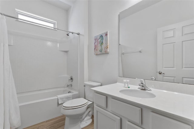 full bathroom with vanity, shower / bath combination with curtain, hardwood / wood-style floors, and toilet