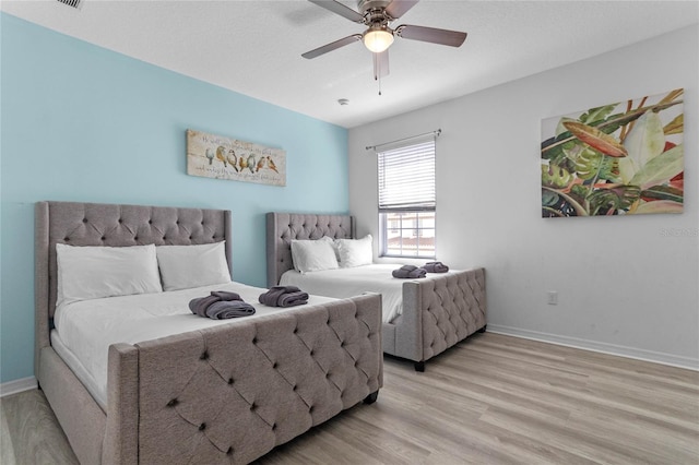 bedroom with ceiling fan and light hardwood / wood-style flooring