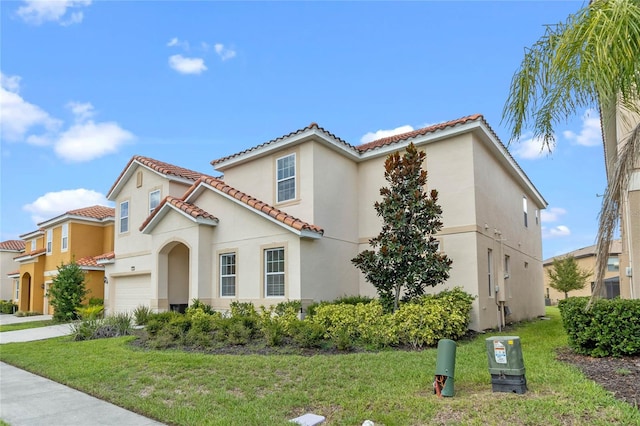 mediterranean / spanish-style house with a front lawn and a garage