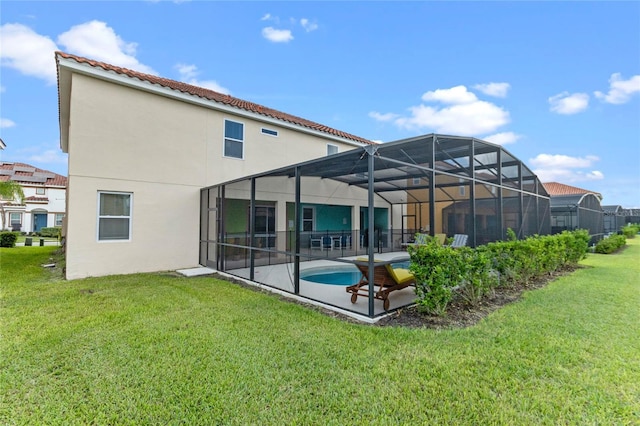 back of property featuring a patio area, a lanai, and a yard