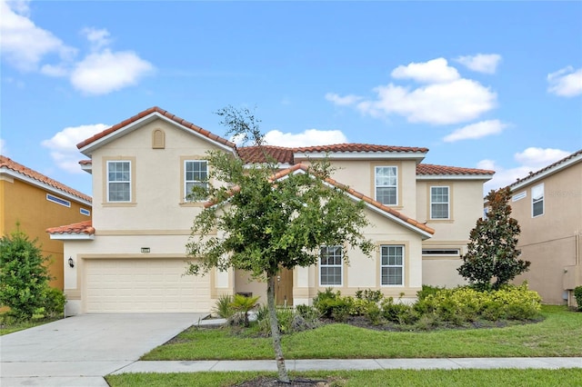 mediterranean / spanish house featuring a front lawn and a garage