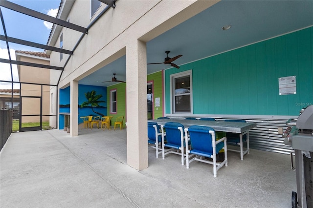 view of patio featuring a lanai and ceiling fan