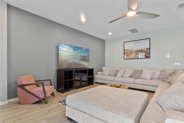 living room with ceiling fan and light hardwood / wood-style flooring