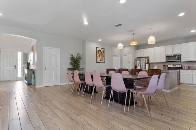 dining area with light hardwood / wood-style floors