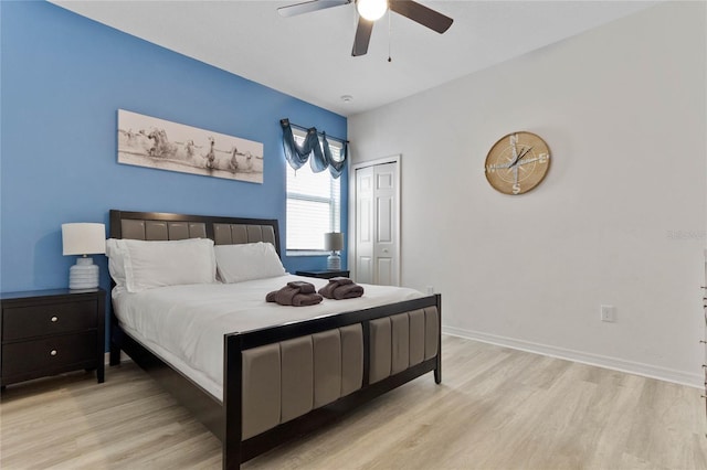 bedroom with a closet, ceiling fan, and light wood-type flooring