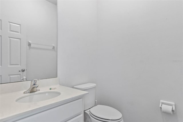 bathroom featuring toilet and vanity