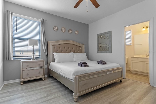 bedroom with light hardwood / wood-style floors, ceiling fan, and ensuite bathroom