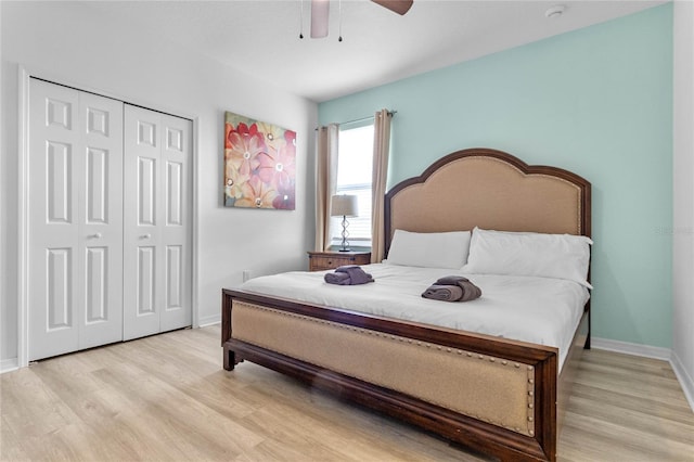 bedroom with ceiling fan, light hardwood / wood-style floors, and a closet