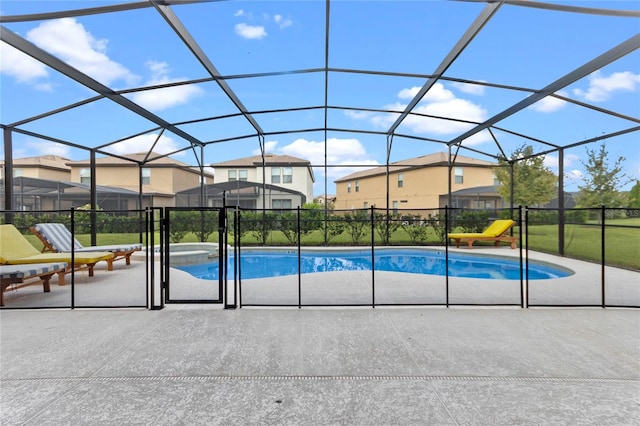 view of swimming pool featuring a lawn, a patio, and a lanai