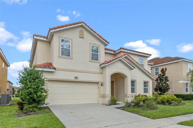 mediterranean / spanish-style home with central AC unit, a front yard, and a garage