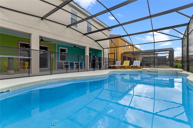 view of pool featuring an in ground hot tub and glass enclosure